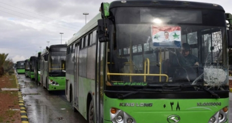 Des bus en file d'attente pour l'évacuation de civils et de rebelles en attente le 14 décembre 2016 à Alep.