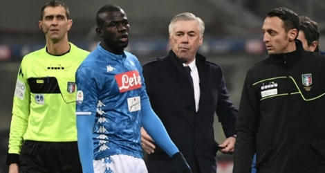 Le défenseur sénégalais de Naples Kalidou Koulibaly, devant son entraîneur Carlo Ancelotti (c), vient de recevoir un carton jaune contre l'Inter, le 26 décembe 2018 à Milan.