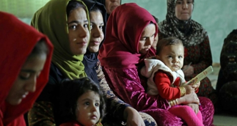Des femmes accompagnées d'enfants écoutent une militante s'exprimant contre la mutilation génitale féminine, dans le village de Charboty Saghira, dans le Kurdistan irakien où l'excision est répandue, le 3 décembre 2018 