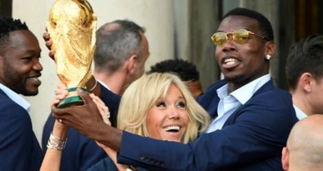 Paul Pogba à l'Elysée avec Brigitte Macron, soiulève le trophée de la Coupe du monde, le 16 juillet 2018.