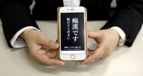 Un responsable de la police tient un téléphone contenant l'application «Digi police», à Tokyo, le 13 mai 2019.