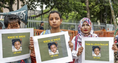 Des femmes brandissent des photos de Nusrat Jahan Rafi, une étudiante brûlée vive, le 12 avril 2019, à Dacca (Bangladesh).