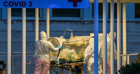 Equipe médicale avec un patient en soins intensifs amené dans une aile dédiée aux patients atteints du Covid-19, le 16 mars 2020 à l'hôpital Gemelli, à Rome.