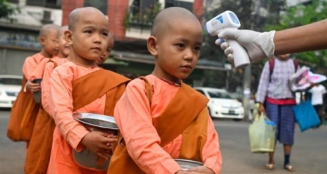 Prises de températures sur des jeunes moines birmans à Rangoon, le 21 mars 2020.