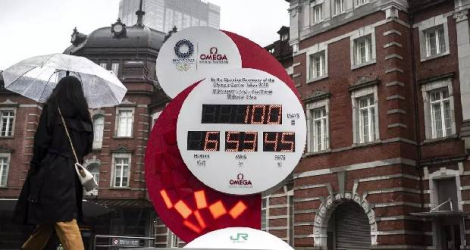 Une horloge du compte à rebours des Jeux olympiques et paralympiques de Tokyo 2020, 100 jours avant la cérémonie d’ouverture, à l'extérieur d'une gare de Tokyo, le 14 avril 2021 Charly TRIBALLEAU AFP